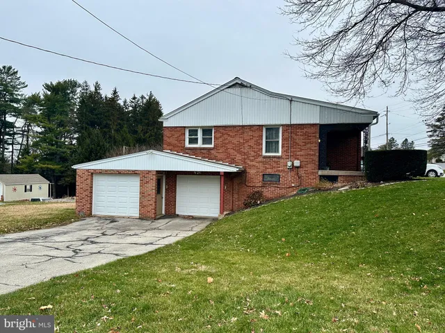 a front view of a house with yard