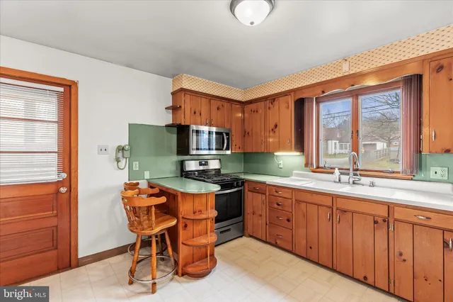 a kitchen with a sink cabinets and window