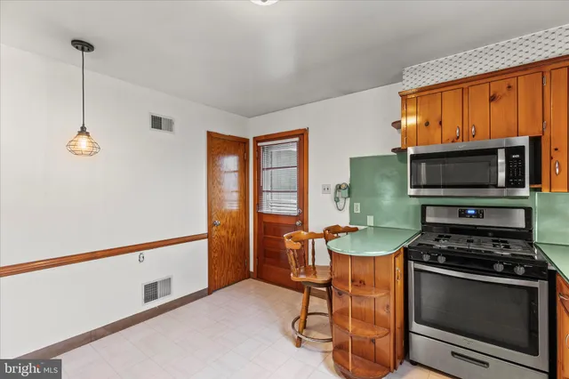 a kitchen with stainless steel appliances a stove a sink and a microwave