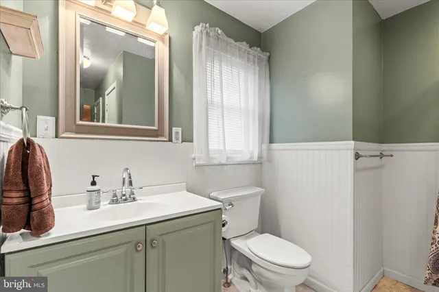 a bathroom with a sink toilet and mirror
