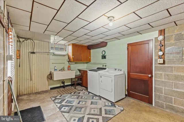 a room with furniture a large window and white walls