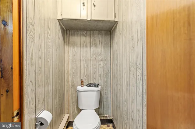 a bathroom with a sink a toilet and shower curtain