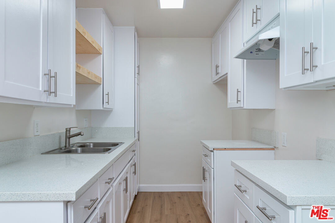 12572 Washington Boulevard, Unit 2 Los Angeles, CA 90066 - Photo 13 of 19 a kitchen with white cabinets and sink