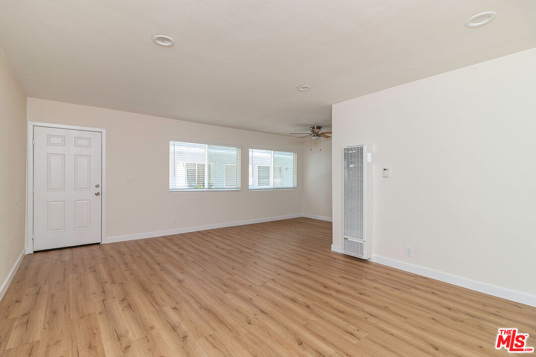12572 Washington Boulevard, Unit 2 Los Angeles, CA 90066 - Photo 16 of 19 a view of an empty room with wooden floor and a window
