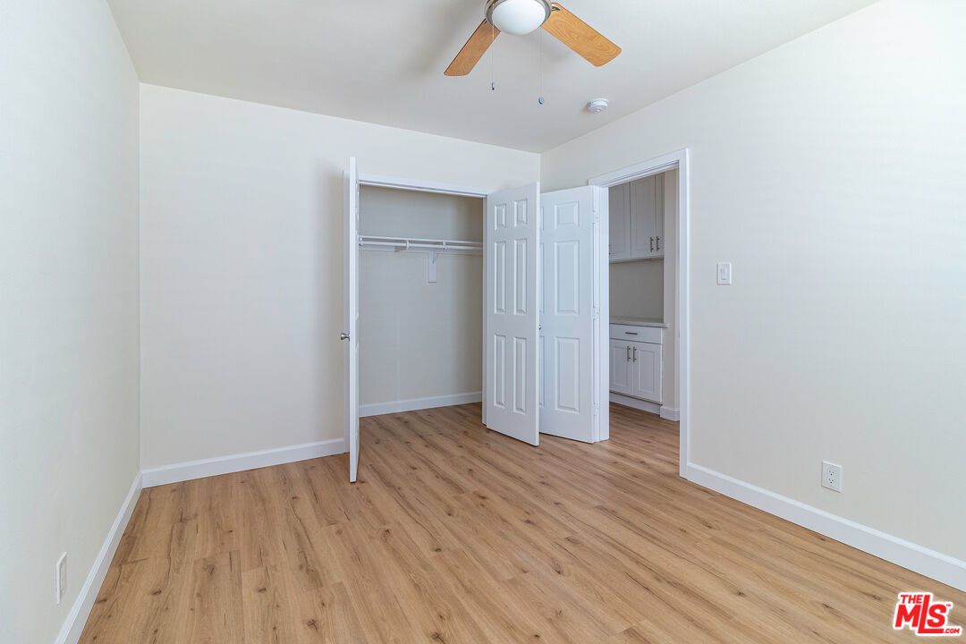 12572 Washington Boulevard, Unit 2 Los Angeles, CA 90066 - Photo 2 of 19 an empty room with wooden floor and ceiling fan