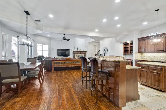 a kitchen with a table chairs refrigerator and chairs