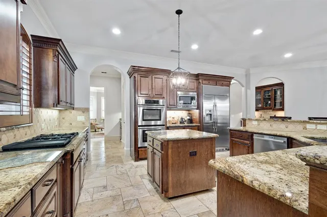 a kitchen with stainless steel appliances granite countertop counter space a sink stove and refrigerator