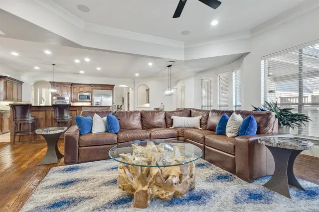 a living room with lots of furniture and view of kitchen