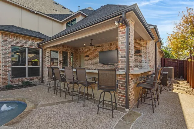 a view of a patio with table and chairs with wooden floor and fence