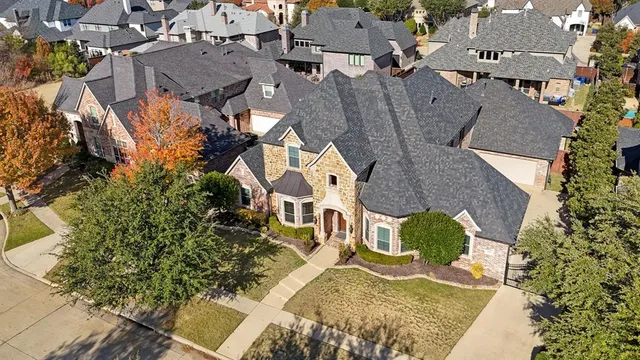 an aerial view of residential houses with outdoor space