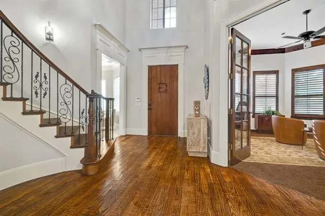 a view of an entryway with wooden floor and windows
