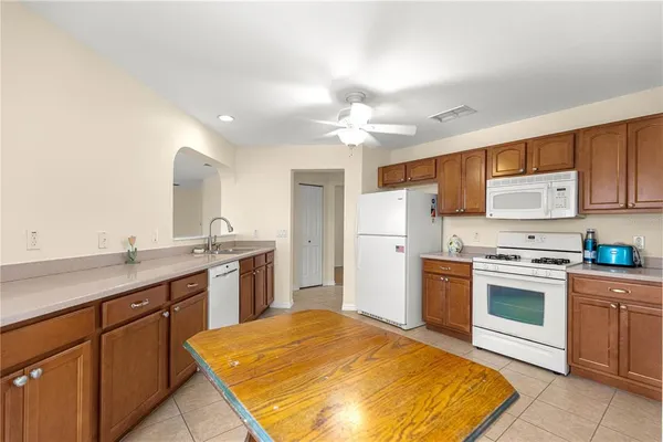 a kitchen with a sink stove and refrigerator