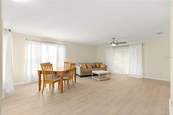 a living room with furniture and large windows