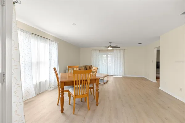 a view of a dining room with furniture and a window