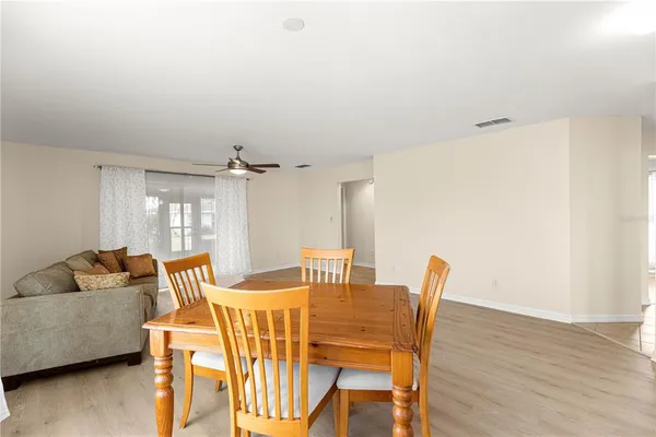 a dining room with furniture and wooden floor