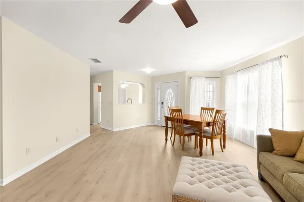 a dining room with furniture and wooden floor