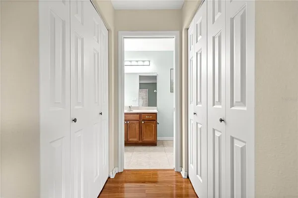 a view of a hallway with a livingroom and a bathroom