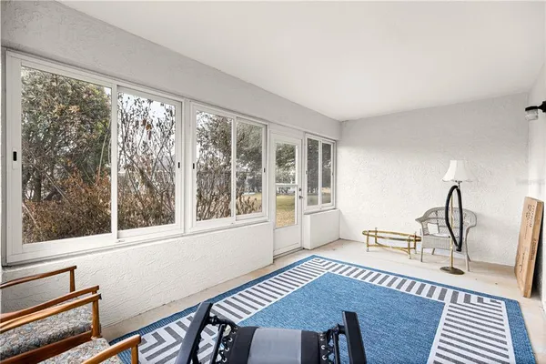 a view of a living room and a window with wooden floor