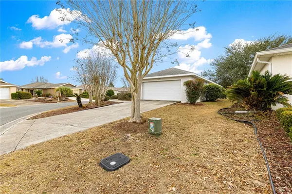 a view of yard covered with snow in front of house