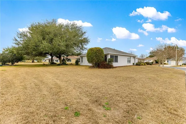 a view of a house with a yard and garage