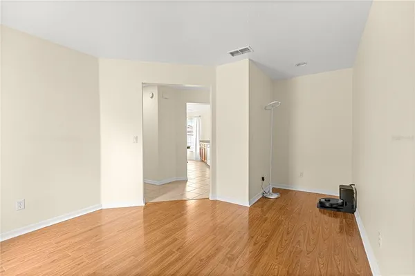 a view of a room with wooden floor and a bathroom