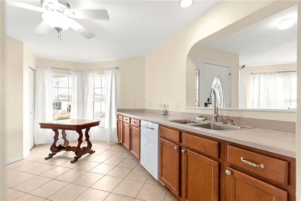 a spacious bathroom with a double vanity sink a mirror and a bathtub