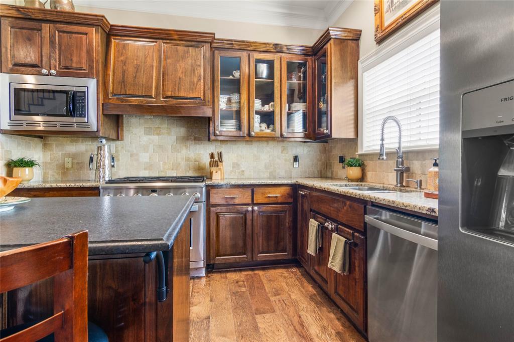 40 Enclave Court Waco, TX 76708 - Photo 9 of 40 a kitchen with stainless steel appliances granite countertop a stove a sink and a microwave