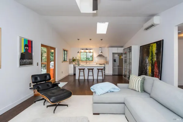 a living room with furniture and a piano