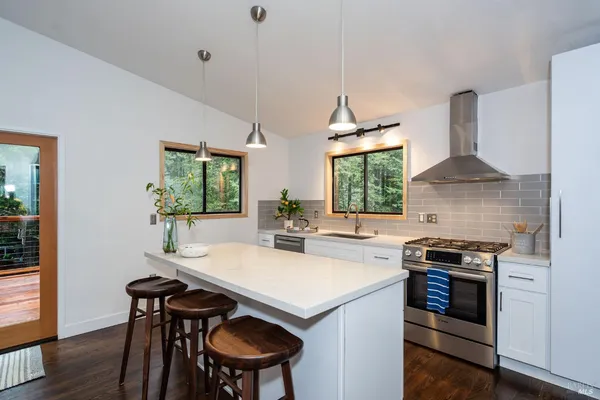 a kitchen with a stove a sink and a refrigerator