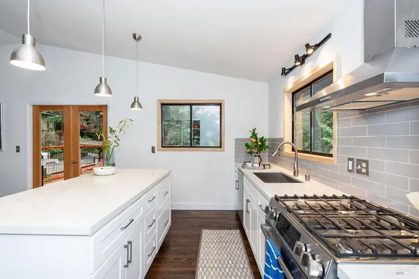 a kitchen that has a stove and a sink