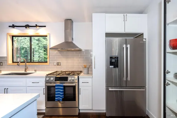 a kitchen with a stove and a refrigerator
