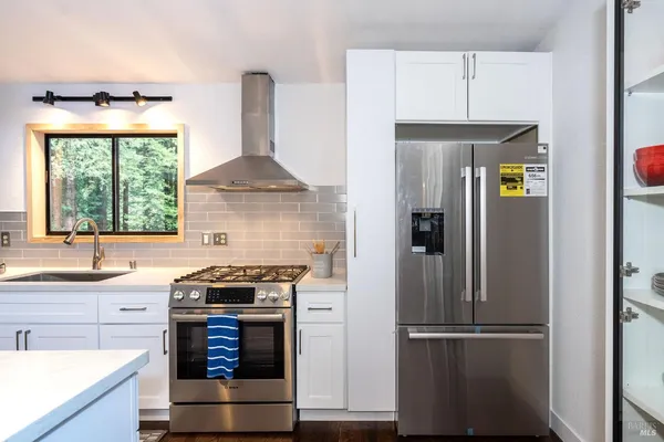 a kitchen with a stove and a refrigerator