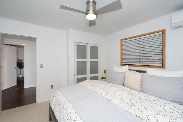 a bedroom with a large bed and a window