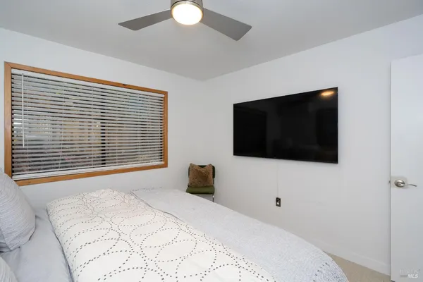 a bedroom with a bed and a flat screen tv