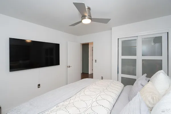 a bedroom with a bed and a flat screen tv