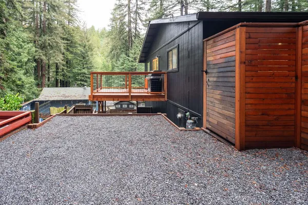 a view of a chairs and table in the back yard