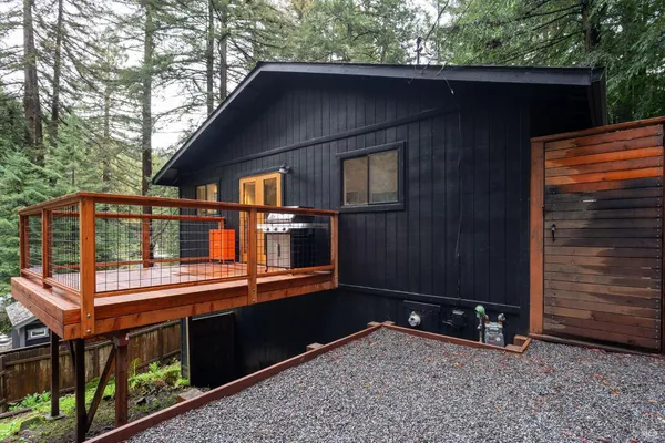 a backyard of a house with barbeque oven and outdoor seating