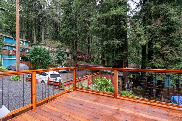 a view of a balcony with floor to ceiling window next to a yard