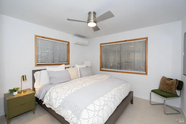 a bedroom with a bed and a large window