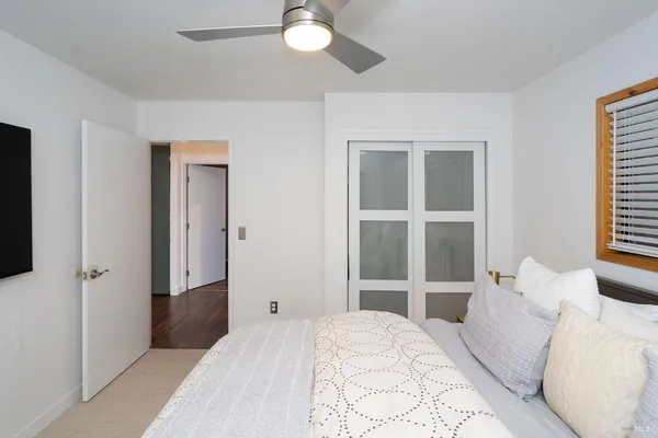 a bedroom with a bed and a large window