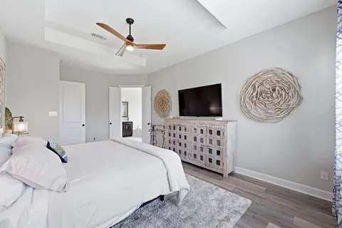 a bedroom with a bed and a flat screen tv