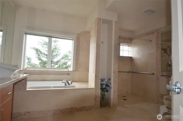 a bathroom with a bathtub and a shower