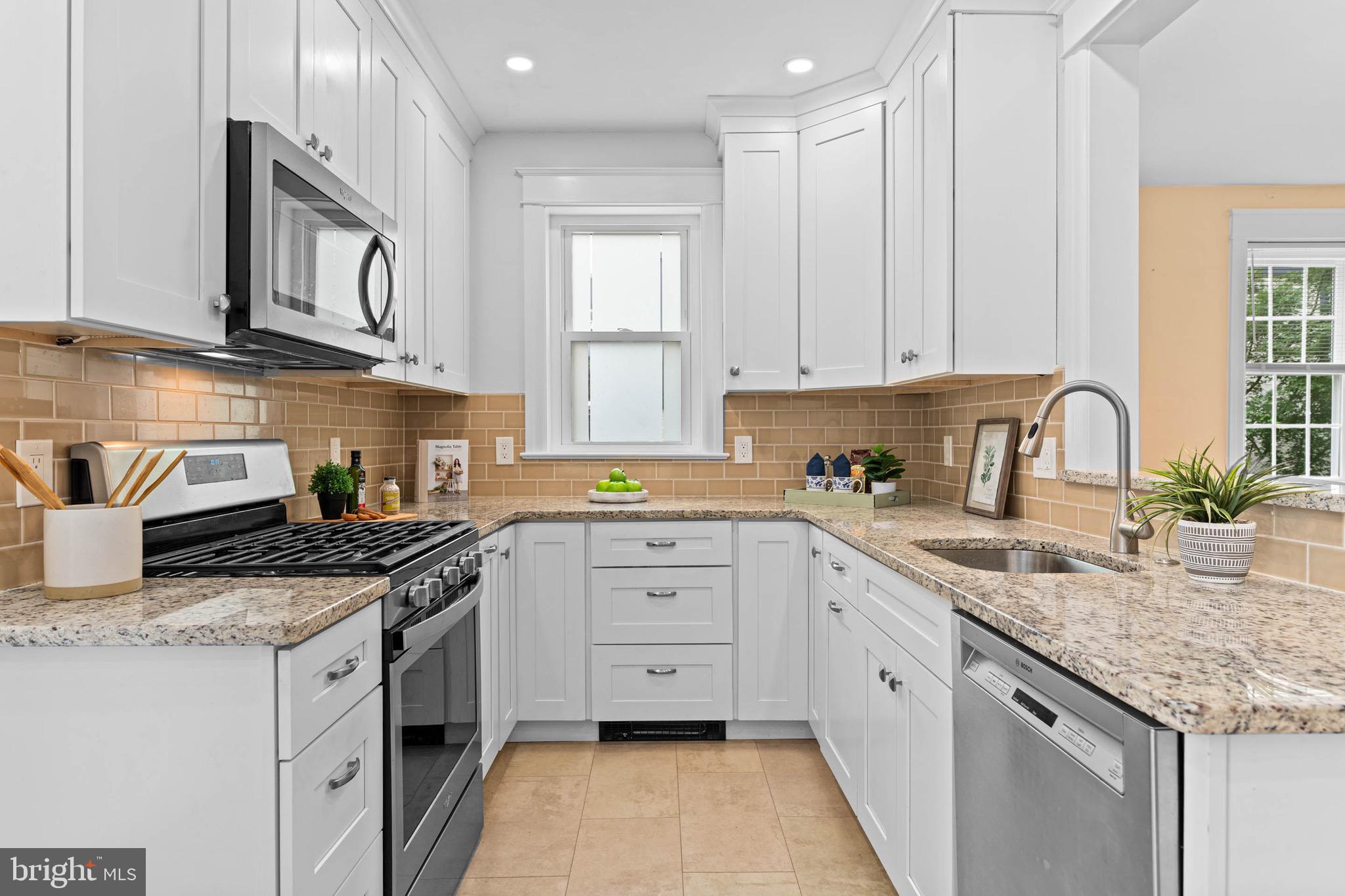 32 Chatham Road Ardmore, PA 19003 - Photo 12 of 29 a kitchen with granite countertop white cabinets white stainless steel appliances with a sink and dishwasher