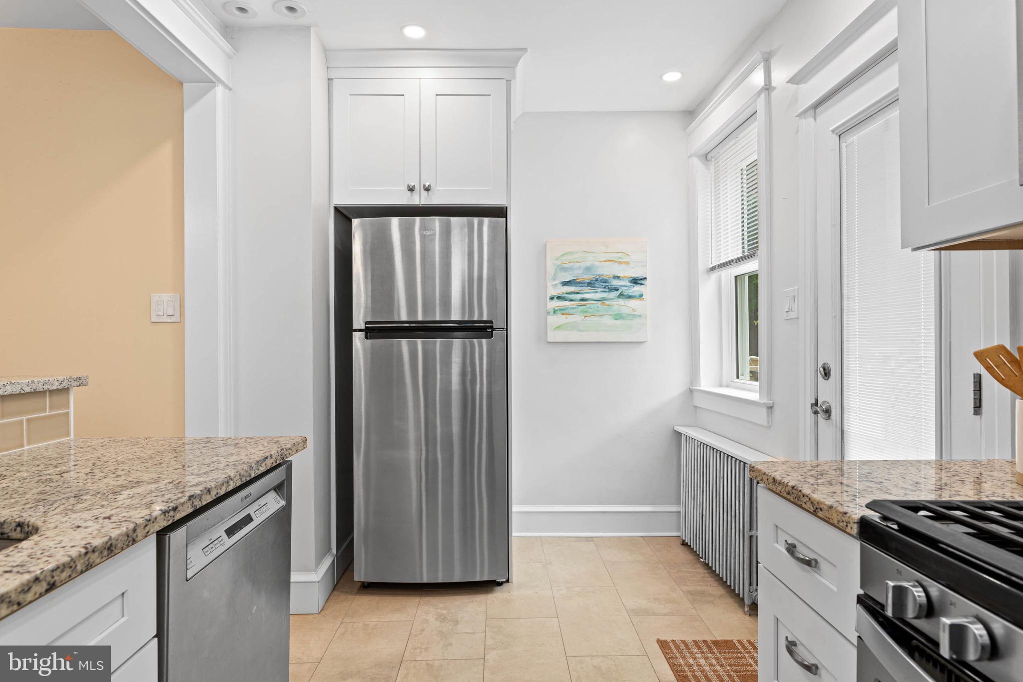 32 Chatham Road Ardmore, PA 19003 - Photo 13 of 29 a kitchen with kitchen island granite countertop a refrigerator and a sink
