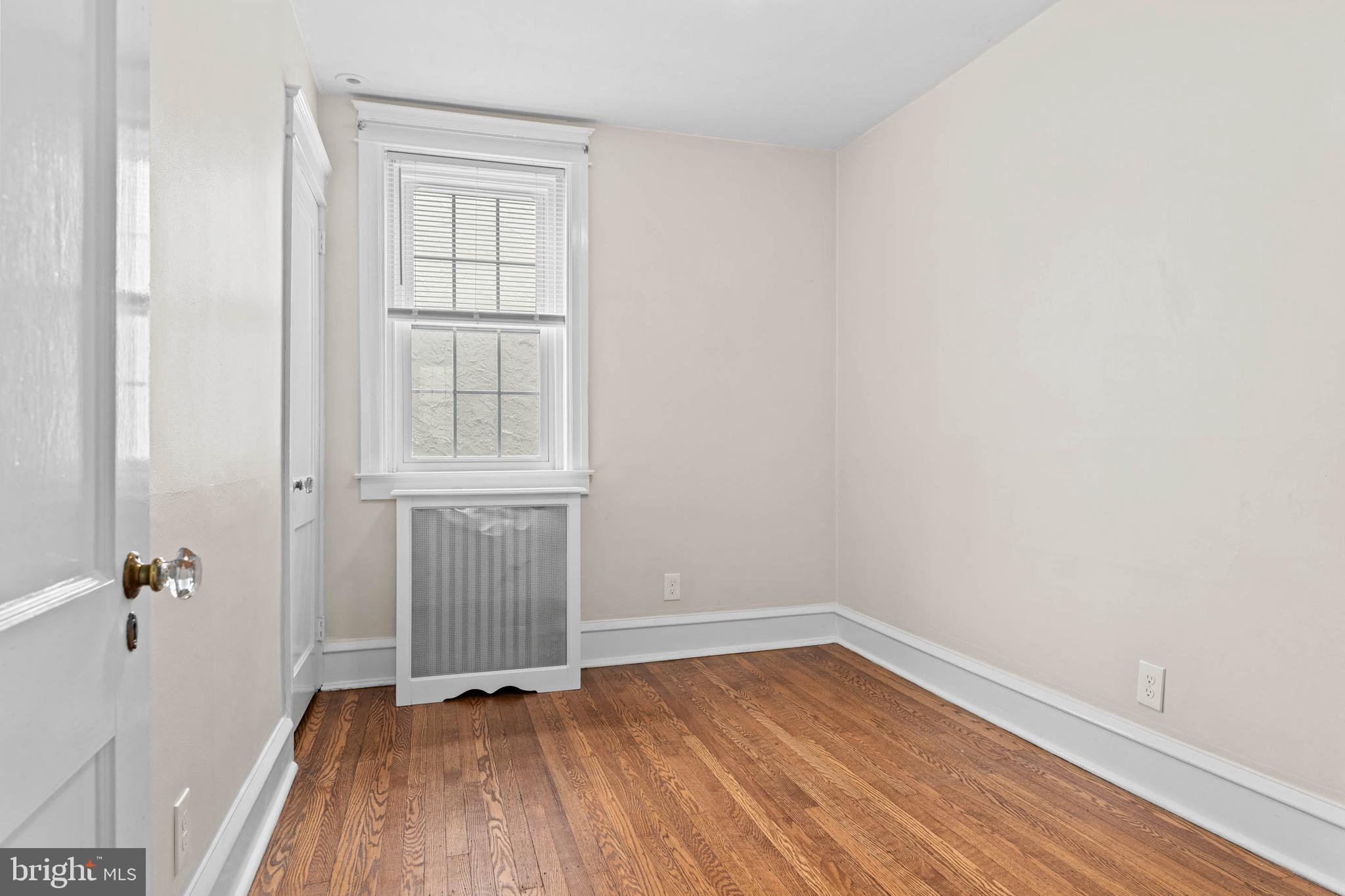 32 Chatham Road Ardmore, PA 19003 - Photo 22 of 29 an empty room with wooden floor and windows