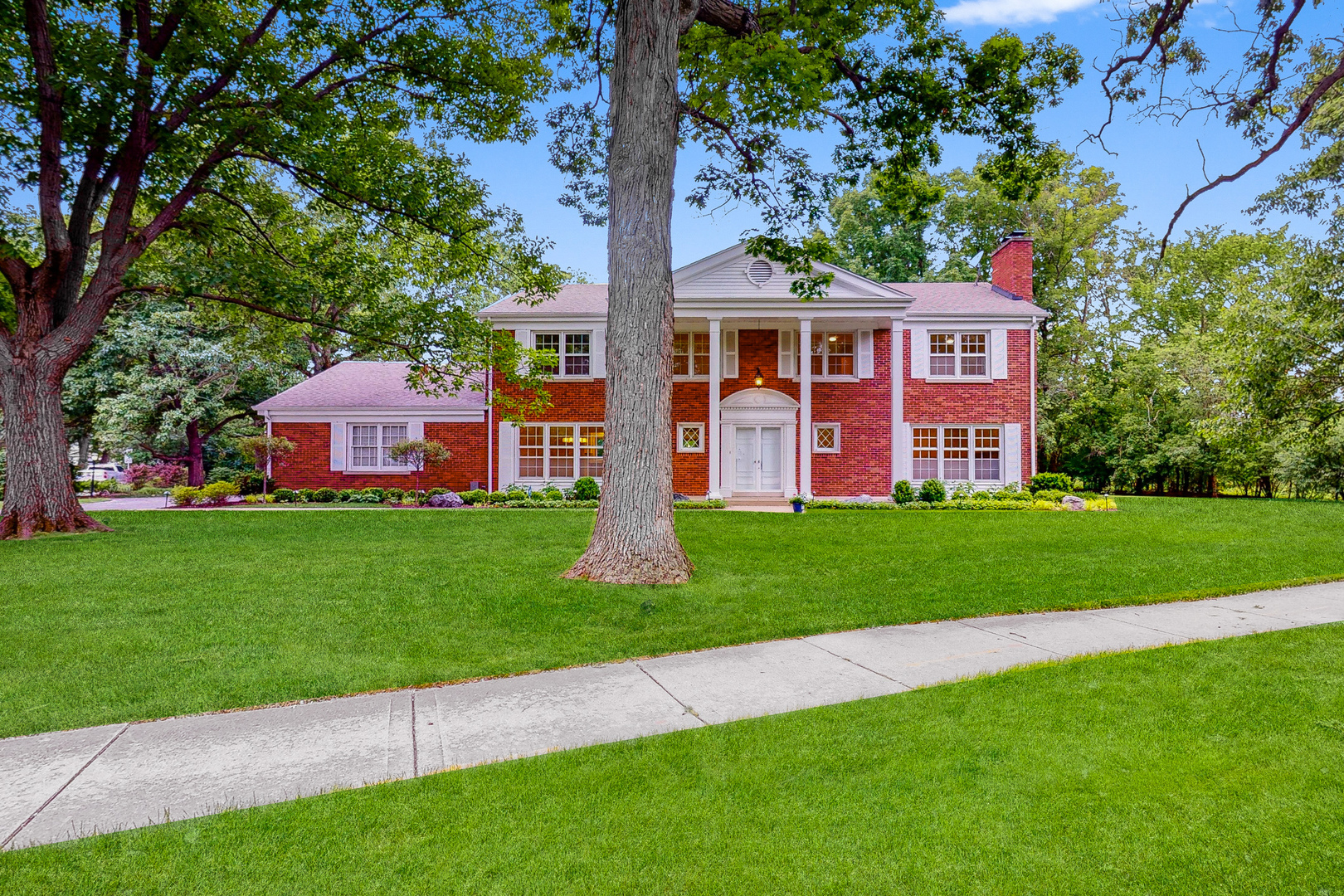 2100 Burr Oak Drive Glenview, IL 60025 - Photo 1 of 38 a front view of a house with a garden