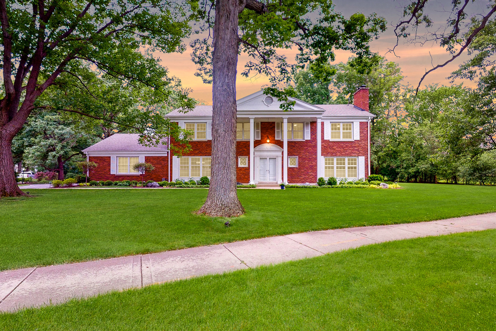 2100 Burr Oak Drive Glenview, IL 60025 - Photo 2 of 38 a front view of a house with a garden