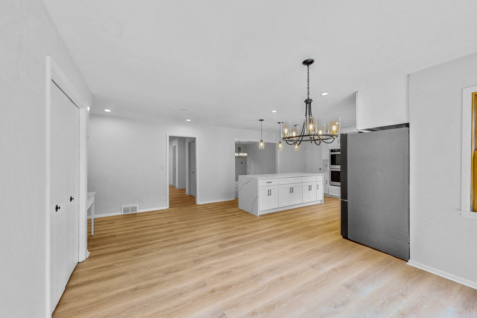 2100 Burr Oak Drive Glenview, IL 60025 - Photo 9 of 38 a large room with kitchen view and a refrigerator