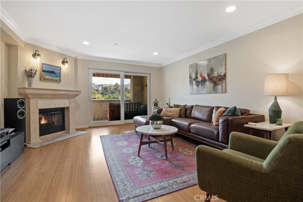 6221 Monterey Road, Unit 304 Highland Park, CA 90042 - Photo 1 of 27 a living room with furniture a large window and a fireplace