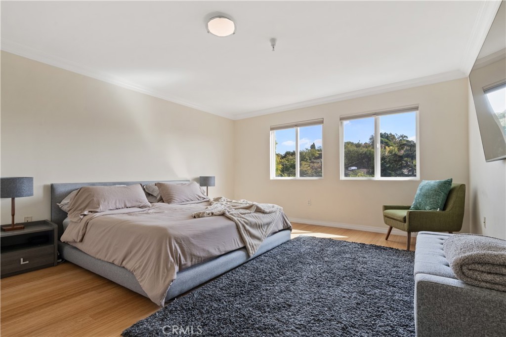 6221 Monterey Road, Unit 304 Highland Park, CA 90042 - Photo 19 of 27 a bedroom with a bed and wooden floor
